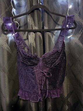 Purple velvet corset top with lace up front and ruffle straps